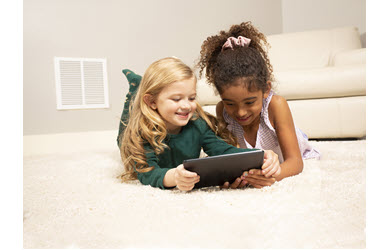two girls read tablet on clean carpet
