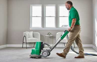 carpet cleaning service tech cleans carpet