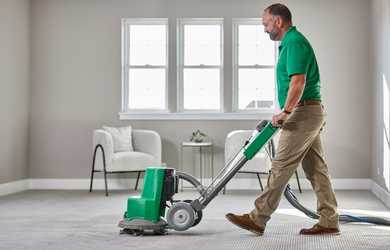 Carpet cleaner uses machine to clean carpet