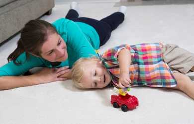 mom and son play on clean carpet